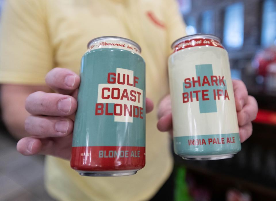 Co-owner Rob Moehle shows some of their unique cans at Doc’s Hop Shop in Pensacola on Thursday, Dec. 8, 2022.