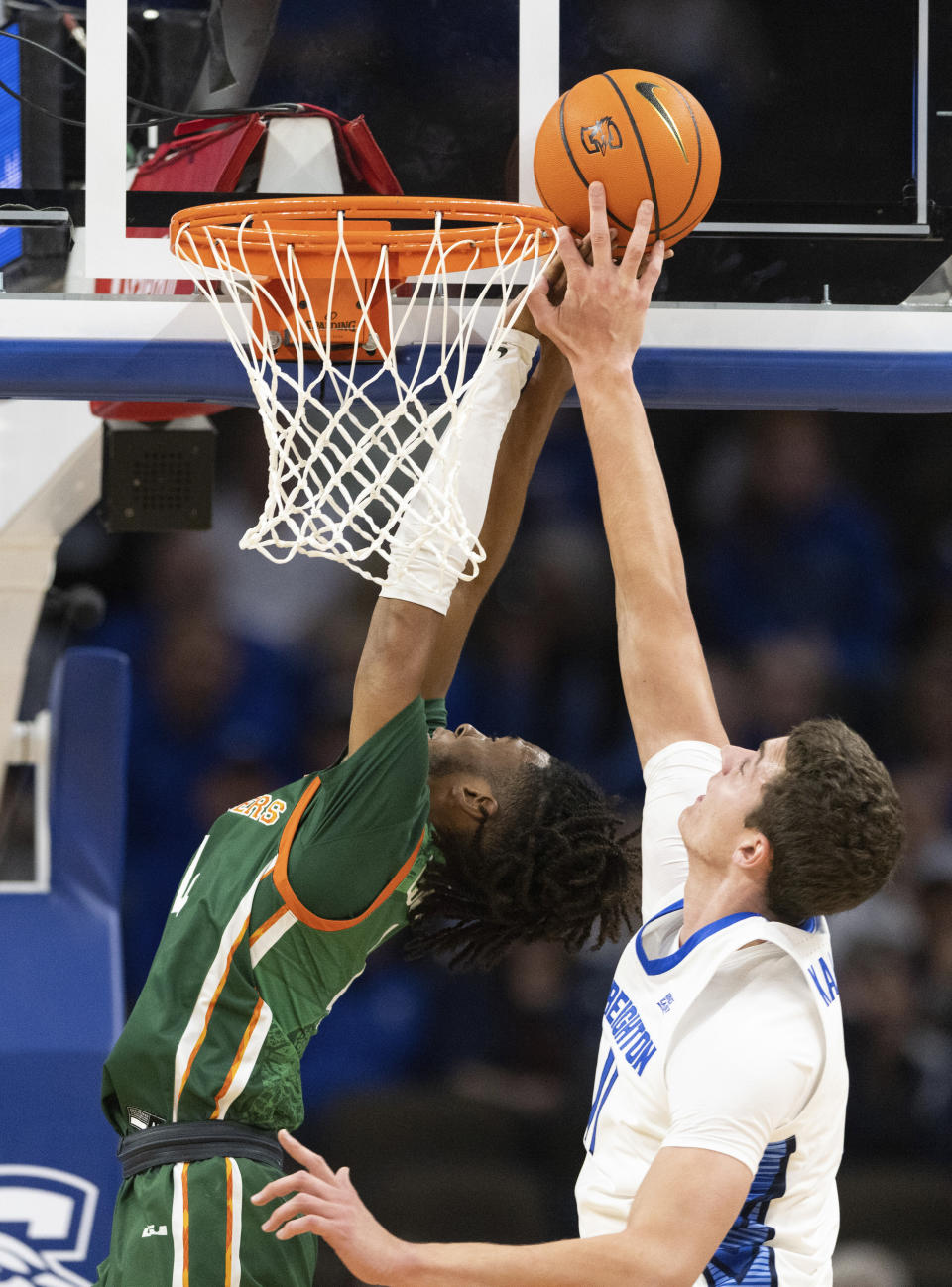 Creighton's Ryan Kalkbrenner, right, swats away a shot by Florida A&M's Hantz Louis-Jeune during the first half of an NCAA college basketball game on Tuesday, Nov. 7, 2023, in Omaha, Neb. (AP Photo/Rebecca S. Gratz)