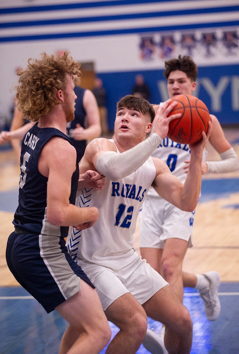 Wynford's Grant McGuire goes up for a shot over Carey's Kyler Boes.