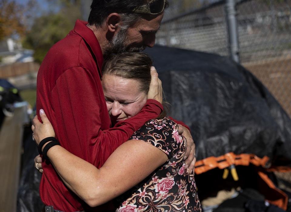Julie Gommon and Doug Koogle hug while cleaning up their camp at Herman Franks Park in Salt Lake City on Friday, Oct. 27, 2023. Both Gommon and Koogle said they would live in a sanctioned camp if possible. They need a place to safely store their belongings while at work. | Laura Seitz, Deseret News
