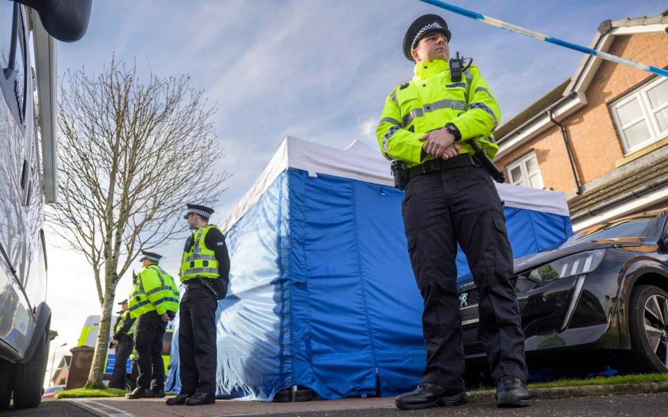 Police Scotland officers are pictured this morning outside the home of Peter Murrell and Nicola Sturgeon - Wattie Cheung