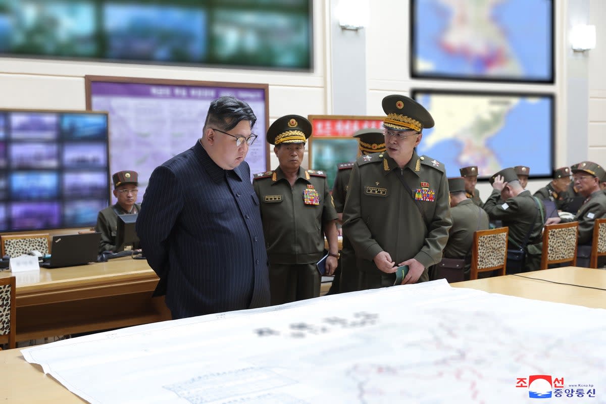 A photo released by KCNA shows Kim Jong-un (left), accompanied by Korean People’s Army Marshal Pak Jong Chon (centre) and Minister of National Defence General Kang Sun Nam (right), visiting a training command post at an undisclosed location in North Korea on 29 August (EPA)