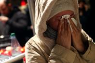 People attend a vigil for the victims of a shooting in Hanau