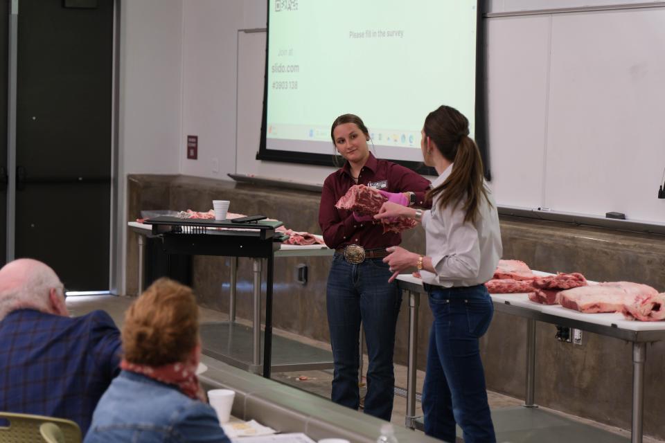 A member of the WT meat judging team shows off a shank of meat Tuesday at a One West Campaign Steering Committee Meeting at West Texas A&M.
