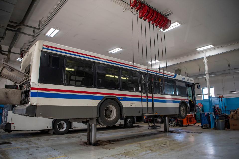 A Battle Creek Transit bus is lifted inside the maintenance garage on Tuesday, April 5, 2022.