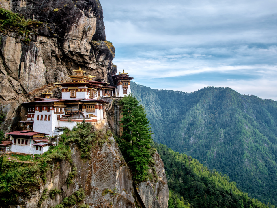 <p>Majestically woven into the mountainside near Paro, Bhutan, sits Taktsang Palphug Monastery. Equally dramatic as it is stunning, this Buddhist temple complex–commonly known as the Tiger’s Nest– is Bhutan’s most prominent landmark. </p><p>Reaching the monastery requires a 4-5 hour round trip hike, but the views are well-worth the early wake-up call and 1,700 foot elevation gain. The entire path is carpeted with colorful prayer flags, vibrant prayer wheels, and unobstructed views of the monastery. There’s no better time to visit than this upcoming October, when the long-awaited <a rel="nofollow noopener" href="http://www.sixsenses.com/six-senses-bhutan-prepares-for-oct-2018-opening" target="_blank" data-ylk="slk:Six Senses Paro;elm:context_link;itc:0;sec:content-canvas" class="link ">Six Senses Paro</a> property will open its doors just 20 minutes from the trail entrance. Consisting of five resorts spread over Bhutan’s sweeping hills and valleys, the Paro property will ensure a spiritually enlightening stay and visit to Tiger’s Nest, while overlooking the Paro Valley.<br></p>