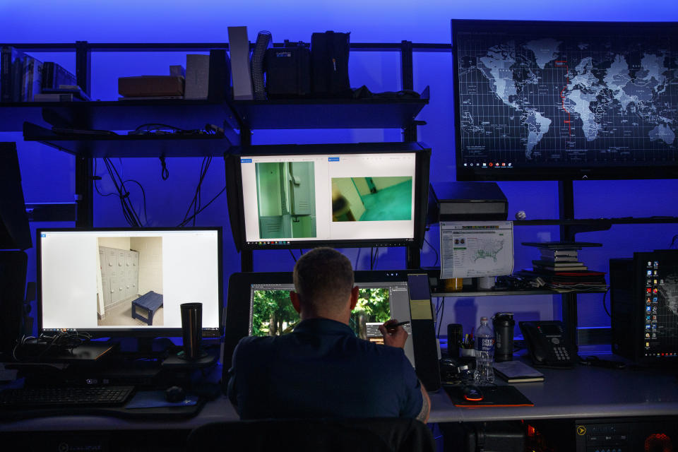 A computer forensic analyst reviews a case inside the Victim Identification Lab, part of Homeland Security's Child Exploitation Investigations Unit, in Fairfax, Va., Friday, Nov. 22, 2019. The Homeland Security Investigations section's little-known Child Exploitation Investigations lab is where agents scour disturbing photos and videos of child sexual abuse. They look for unlikely clues that help them identify the children and bring their abusers to justice. In one case, it was the loud, persistent chirping of a bird. Another time, it was unusual playground equipment. (AP Photo/Jacquelyn Martin)