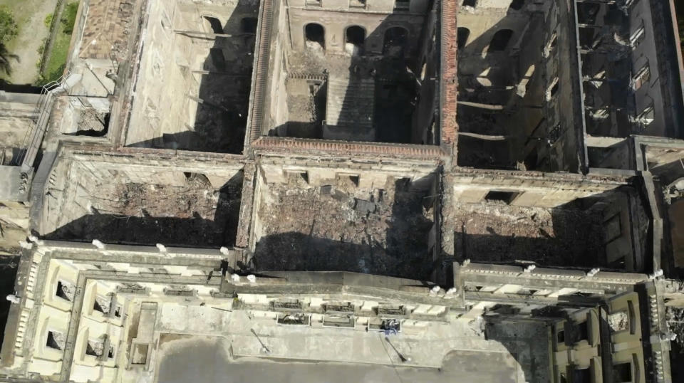 In this Sept. 3, 2018 video grab, the National Museum, seen from above, stands gutted after an overnight fire in Rio de Janeiro, Brazil. A huge fire engulfed Brazil's 200-year-old museum, lighting up the night sky with towering flames as firefighters and museum workers raced to save historical relics from the blaze. (AP Photo/Mario Lobao)