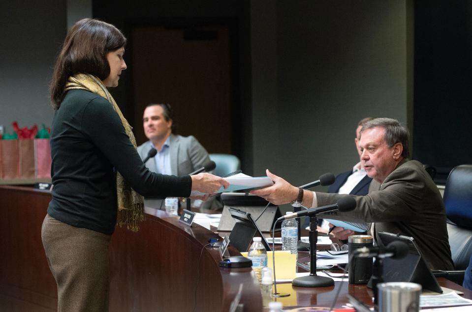 Greta Mills, left, of Jackson, hands Gerald Steen, president of the Madison County Board of Supervisors, a petition containing 400 signatures of people against the addition of an assisted living facility to Livingston, during a meeting in Canton on Thursday. Mills is a member of the Graves family who in 2007 sold the property that is now Livingston in Madison County.