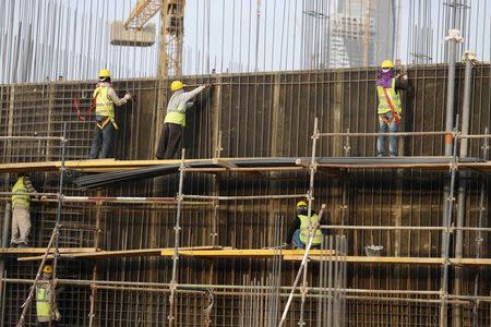 Indian labourers work at the construction site of a building in Riyadh November 16, 2014. REUTERS/Faisal Al Nasser