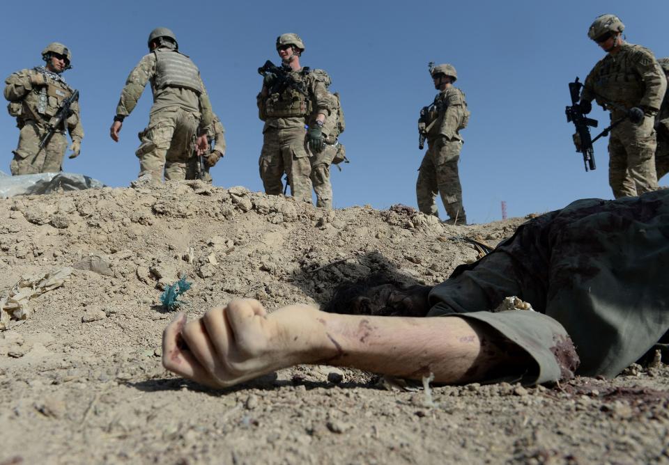 US soldiers over the dead body of an insurgent after a suicide attack in Afghanistan in 2013 (AFP via Getty Images)