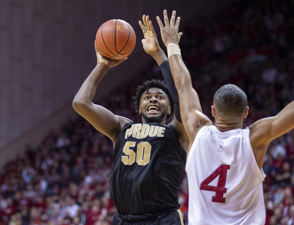 Purdue forward Trevion Williams (50) shoots the ball as Indiana forward Trayce Jackson-Davis (4) defends during the second half of an NCAA college basketball game, Saturday, Feb. 8, 2020, in Bloomington, Ind. Purdue won 74-62. (AP Photo/Doug McSchooler)