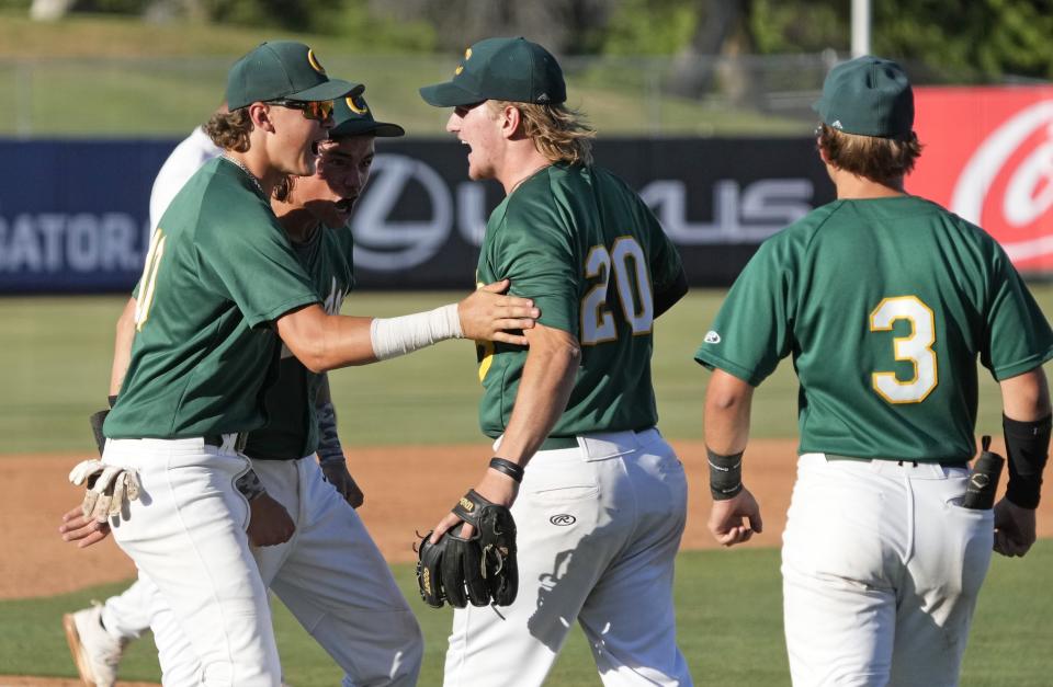 Canyon del Oro celebrates defeating Estrella Foothills during a 4A baseball state tournament semifinal game at Tempe Diablo Stadium on May 8, 2024.