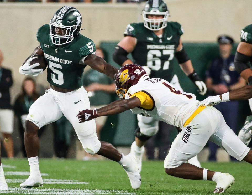 Michigan State running back Nathan Carter (5) runs against Central Michigan defensive back Donte Kent (4) during the first half at Spartan Stadium in East Lansing on Friday, Sept. 1, 2023.