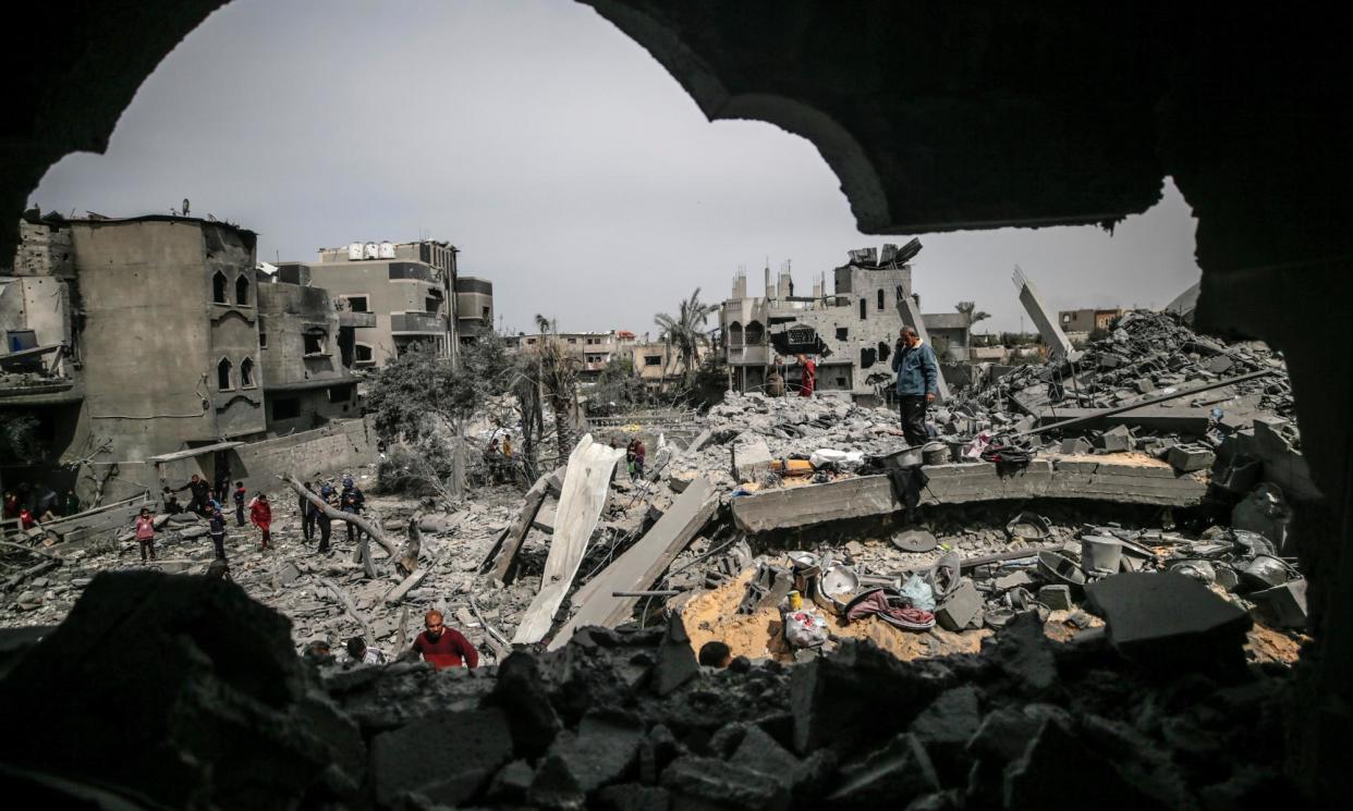 <span>Palestinians search for missing people and victims under the rubble of a home destroyed after an Israeli airstrike in al-Maghazi refugee camp, southern Gaza.</span><span>Photograph: Mohammed Saber/EPA</span>