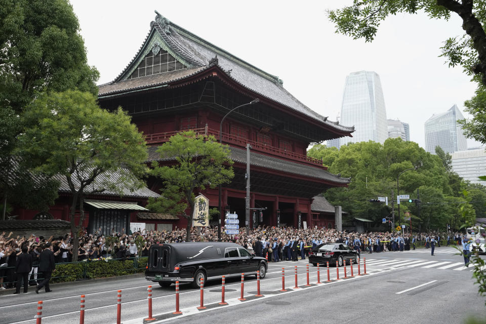 The vehicle carrying the body of former Japanese Prime Minister Shinzo Abe leaves Zojoji temple after his funeral in Tokyo on Tuesday, July 12, 2022. Abe was assassinated Friday while campaigning in Nara, western Japan. (AP Photo/Hiro Komae)