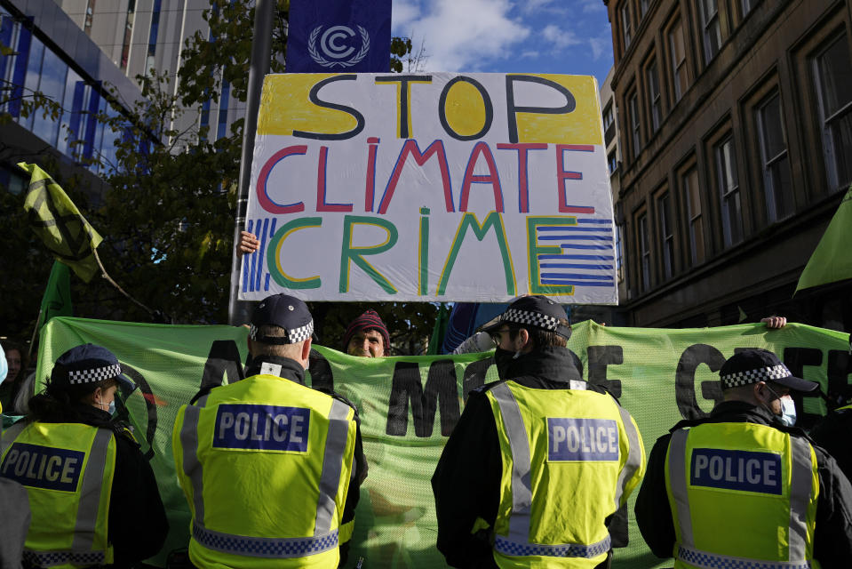 Extension Rebellion activists take part in a demonstration against 'Greenwashing' (an attempt to make people believe that your company or government is doing more to protect the environment than it really is) near the COP26 U.N. Climate Summit in Glasgow, Scotland, Wednesday, Nov. 3, 2021. The U.N. climate summit in Glasgow gathers leaders from around the world, in Scotland's biggest city, to lay out their vision for addressing the common challenge of global warming. (AP Photo/Alastair Grant)