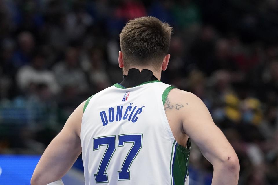 Dallas Mavericks guard Luka Doncic (77) wears tape over the back of his neck as he plays in the first half of an NBA basketball game against the Memphis Grizzlies in Dallas, Sunday, Jan. 23, 2022. (AP Photo/Tony Gutierrez)