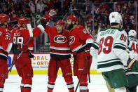 Carolina Hurricanes' Brent Burns celebrates his goal against the Minnesota Wild with Paul Stastny, second from right, Martin Necas (88) and Andrei Svechnikov (37) during the second period of an NHL hockey game in Raleigh, N.C., Thursday, Jan. 19, 2023. (AP Photo/Karl B DeBlaker)