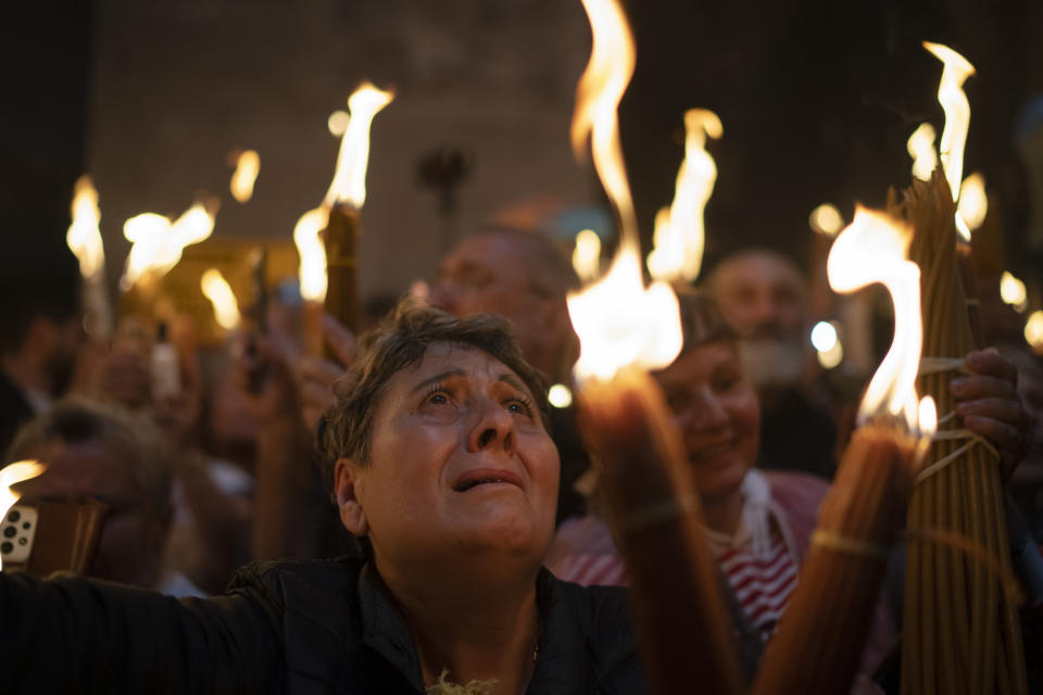 A Christian Orthodox pilgrim holds a candle during the Holy Fire ceremony at the Church of the Holy Sepulchre, where many Christians believe Jesus was crucified, buried and rose from the dead, in the Old City of Jerusalem. Saturday, May 4, 2024. In the annual ceremony that has been observed for over a millennium, a flame taken from Jesus' tomb is used to light the candles of fervent believers of Christian Orthodox communities near and far. The devout believe the origin of the flame is a miracle and is shrouded in mystery. (AP Photo/Leo Correa)