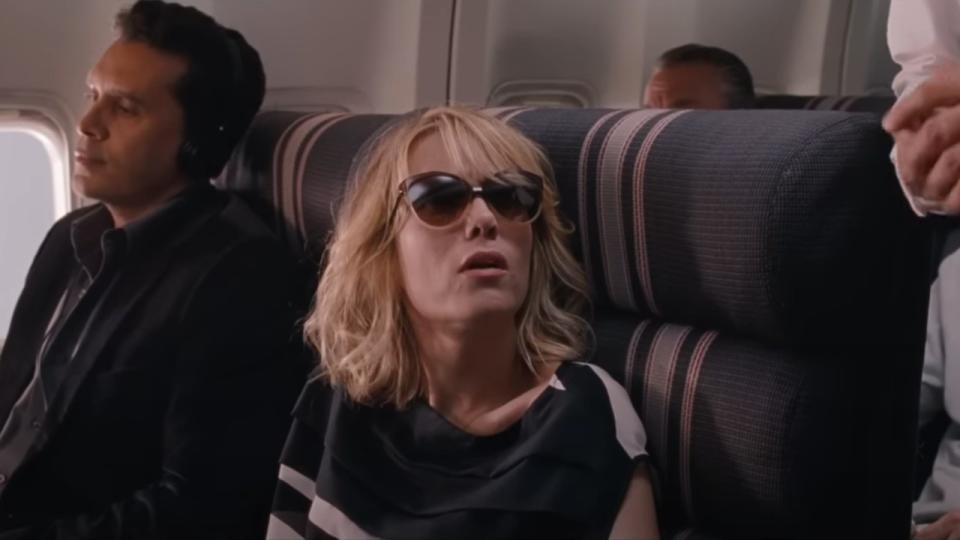 Kristen Wiig wearing sunglasses looking up in Bridesmaids,