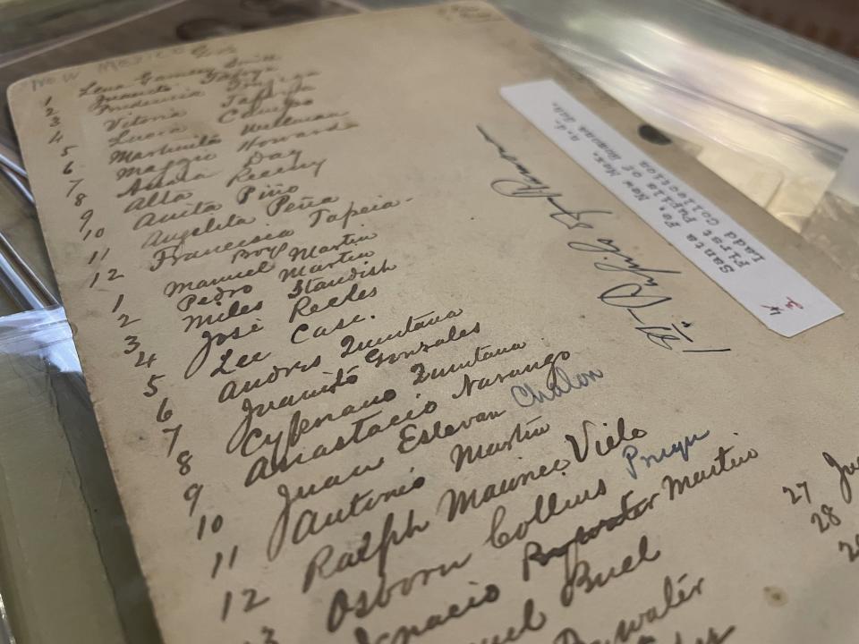 This July 8, 2021 image of material archived at the Center for Southwest Research at the University of New Mexico in Albuquerque, New Mexico, shows a list of names of Indigenous students who attended the Ramona Industrial School in Santa Fe. Many of the late 19th century photographs that make up the Horatio Oliver Ladd Photograph Collection are related to the boarding school. (AP Photo/Susan Montoya Bryan)
