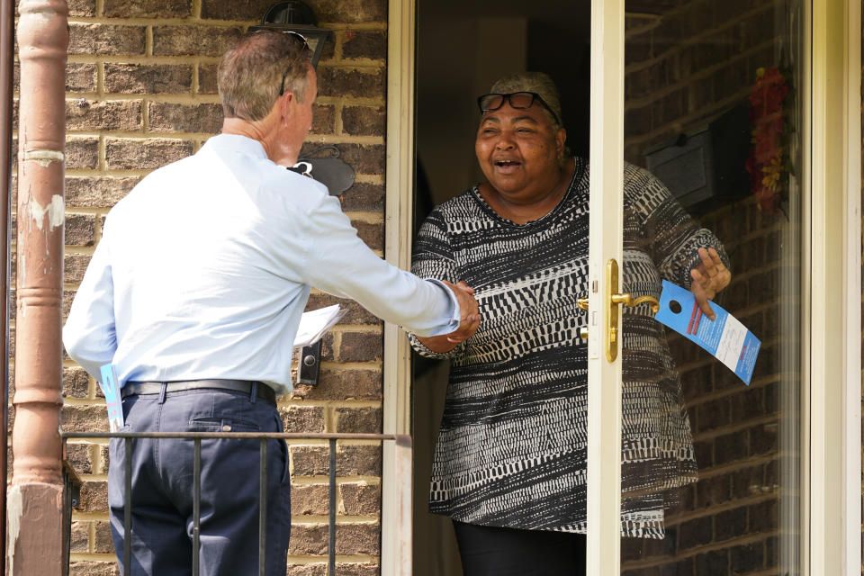 Virginia state Sen. Joe Morrissey, left, talks with a constituent as he canvases a neighborhood, Monday, May 22, 2023, in Petersburg, Va. Morrissey is being challenged in a Democratic primary for a newly redrawn senatorial district by former Delegate Lashrecse Aird. (AP Photo/Steve Helber)