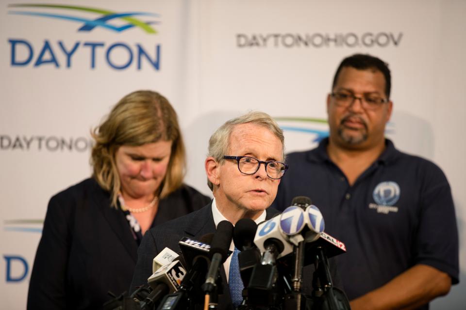 Governor Mike DeWine speaks during a press conference with former Dayton Mayor Nan Whaley (left) and City Commissioner Chris Shaw about a mass shooting that left ten dead, including the shooter on Aug. 4, 2019, in Dayton.