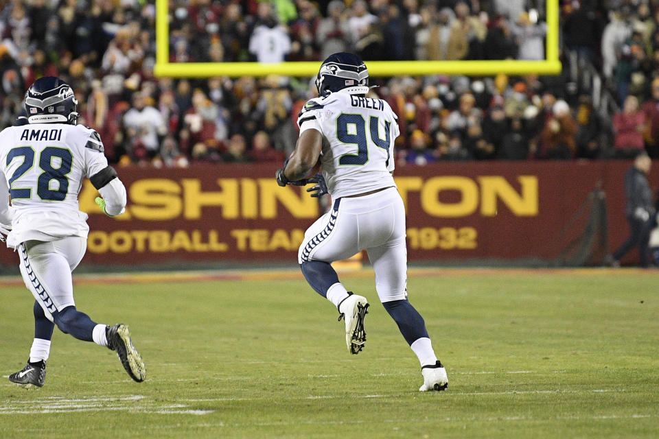 Seattle Seahawks defensive end Rasheem Green (94) runs downfield to score a safety after blocking an extra point attempt by the Washington Football Team during the first half of an NFL football game, Monday, Nov. 29, 2021, in Landover, Md. (AP Photo/Nick Wass)