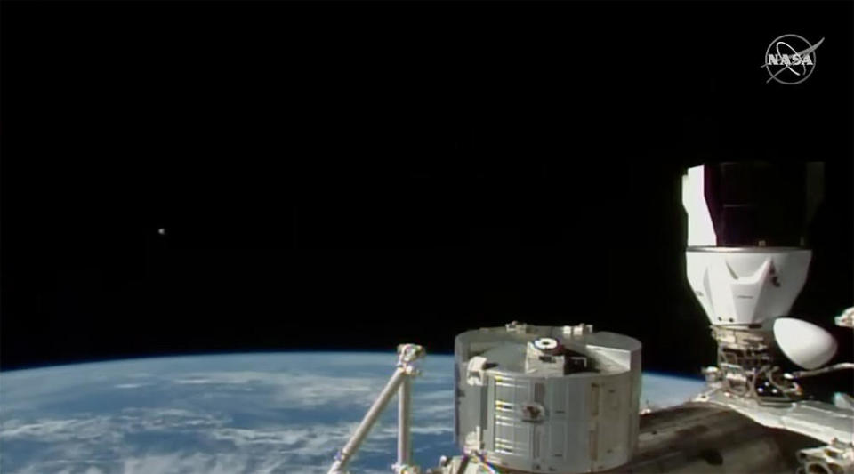 A dramatic shot showing a SpaceX Crew Dragon ferry ship at right as Boeing's Starliner approached the space station in the distance at left. / Credit: NASA