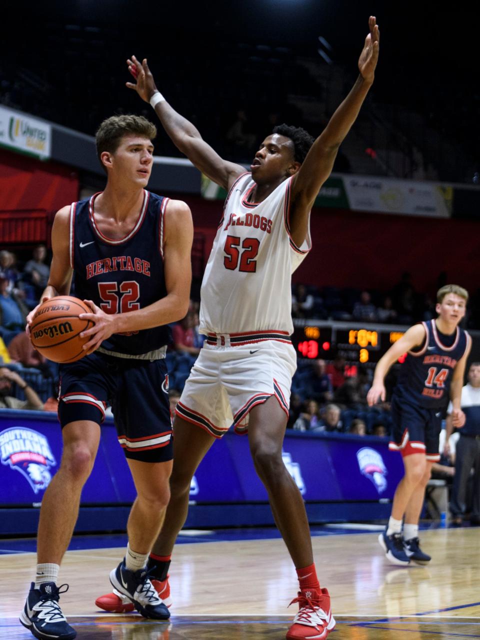 Heritage Hills’ Blake Sisley (52) looks to make a pass around Bosse’s Kiyron Powell (52) during the third quarter of the River City Showcase at Screaming Eagles Arena in Evansville, Ind., Tuesday, Dec. 10, 2019. The Bosse Bulldogs fell to the Heritage Hills Patriots, 82-68.