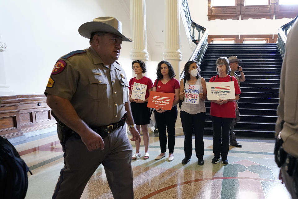 Women with Moms Demand Action gather outside the Texas Senate Chamber as the second day of a state Senate hearing begins, Wednesday, June 22, 2022, in Austin, Texas. The hearing is in response to the recent school shooting in Uvalde, Texas, where two teachers and 19 students were killed. (AP Photo/Eric Gay)