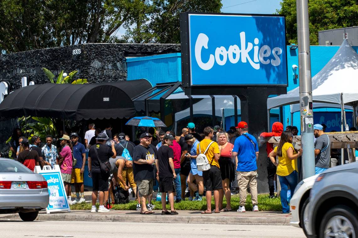 Customers wait in a line that wraps around the dispensary and down the street during the grand opening of Cookies Miami, Florida’s first and only minority-owned marijuana dispensary, in Miami, Florida, on Aug. 13, 2022.