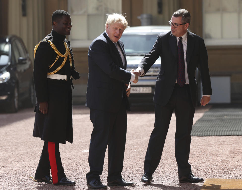 Newly elected leader of the Conservative party Boris Johnson, center, arrives at Buckingham Palace in London for an audience with Queen Elizabeth II where he will be formally invited to become Prime Minister, Wednesday July 24, 2019. Boris Johnson will replace May as Prime Minister later Wednesday, following her resignation last month after Parliament repeatedly rejected the Brexit withdrawal agreement she struck with the European Union. (Yui Mok/pool via AP)