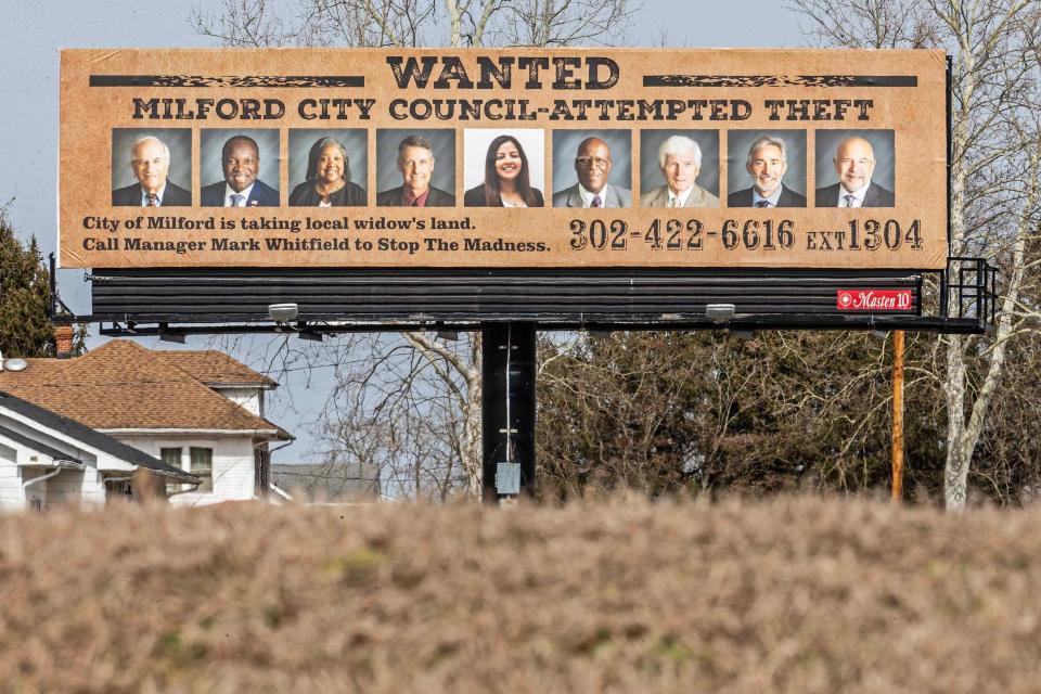 A billboard depicting the city council members who voted for an eminent domain case for Annette Billings' 8 acres of land, now vacated, is featured southbound on route 13 and south of the Redners in Milford, Thursday, Feb. 22, 2024. The billboard was put up by a realtor and accuses the city council members of theft.