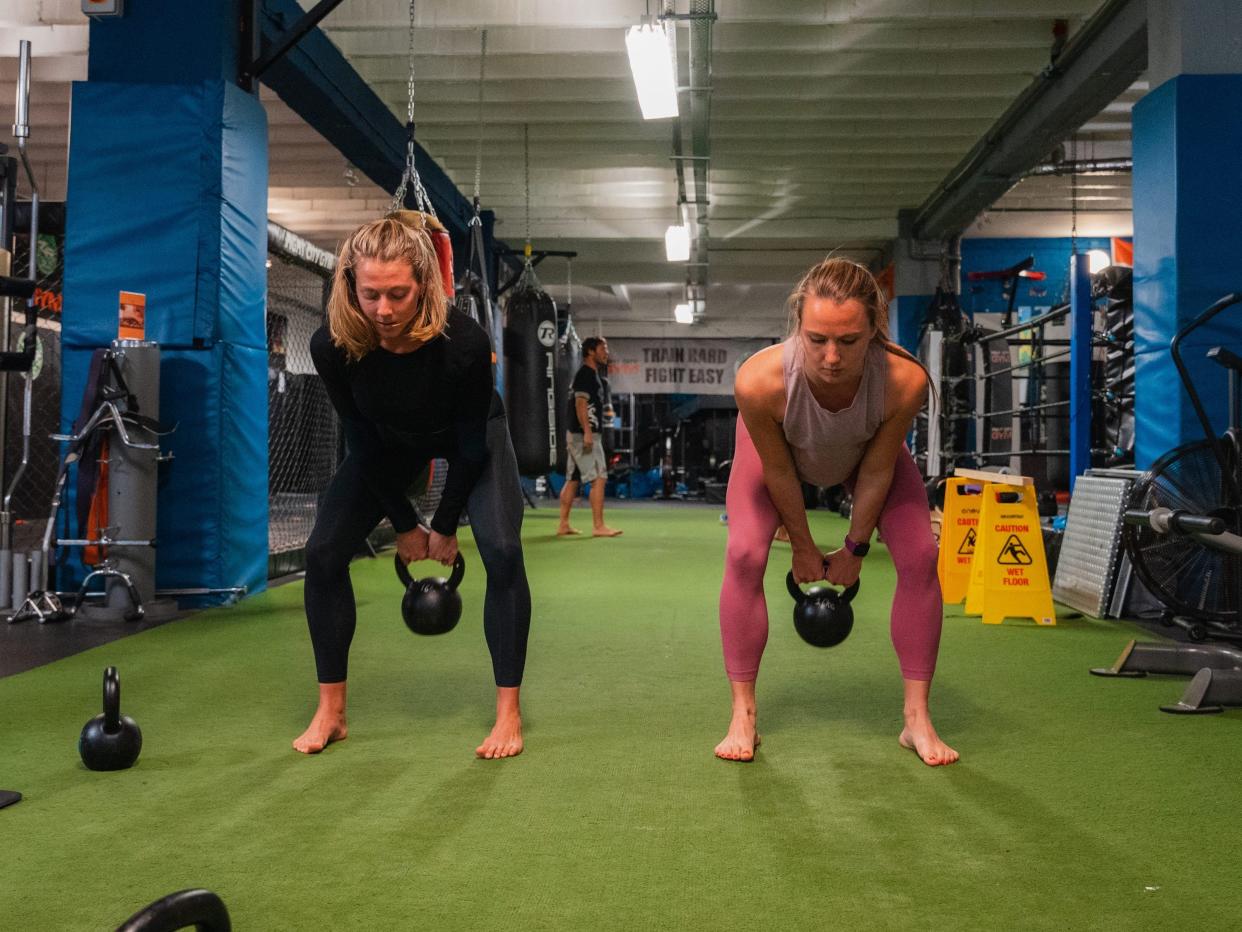 Steph Rose and Rachel Hosie performing a kettlebell swing.