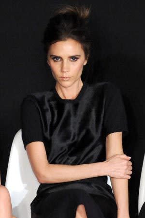 <p>Returning to her signature dark locks, the designer watched on during London Fashion Week Fall/Winter 2013.</p>