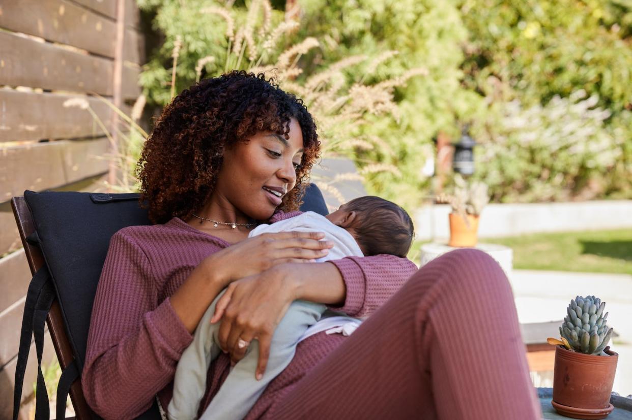 Breastfeeding lowers the risk of diabetes as well as breast and ovarian cancers for mothers. <a href="https://www.gettyimages.com/detail/photo/smiling-mom-holding-her-baby-boy-in-her-arms-while-royalty-free-image/1370476365?phrase=black+mothers+breastfeeding&adppopup=true" rel="nofollow noopener" target="_blank" data-ylk="slk:Goodboy Picture Company/E+ via Getty Images;elm:context_link;itc:0;sec:content-canvas" class="link ">Goodboy Picture Company/E+ via Getty Images</a>