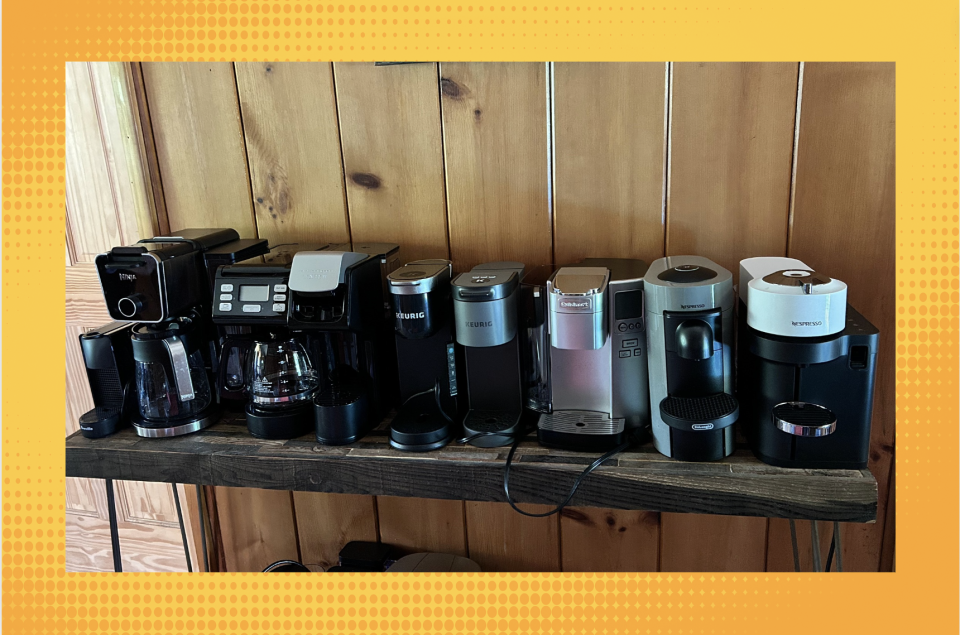 Eight coffee machines lined up on a table.