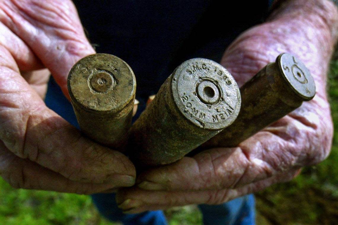 File Photo BONADELLE RANCHOS, CA 2-4-2004 - MTD JRW WWII SHELLS CLOSE UP- Cecil Ray holds a pair of 50-caliber machine gun shell casings, left and right, and a 20mm casing, found with his metal detector on his property in the Bonadelle Ranchos subdivision, once the site of a World War II bombing and shooting target range (ck terminology), behind his home. JOHN WALKER/FRESNO BEE
