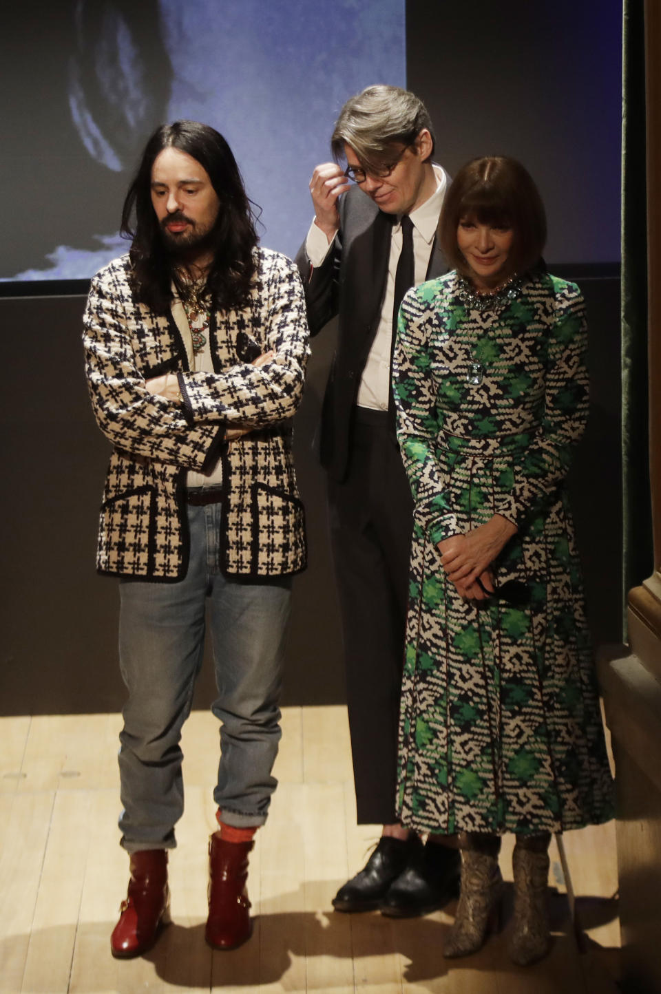 American Vogue editor-in-chief Anna Wintour, right, Gucci creative director Alessandro Michele, left, and curator Andrew Bolton stand during the presentation of this year's Costume Institute exhibition titled ''Camp: Notes on Fashion,'' at the Teatro Gerolamo, in Milan, Italy, Friday, Feb. 22, 2019. The exhibition will be shown at the Metropolitan Museum of Art of New York, from May 9-Sept. 8, 2019. (AP Photo/Luca Bruno)