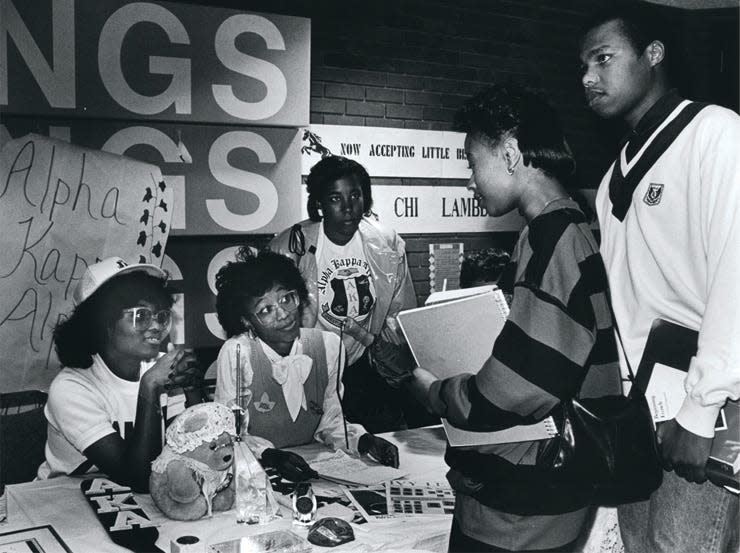 Students check out an Alpha Kappa Alpha Sorority, Inc. table during the 1980s.