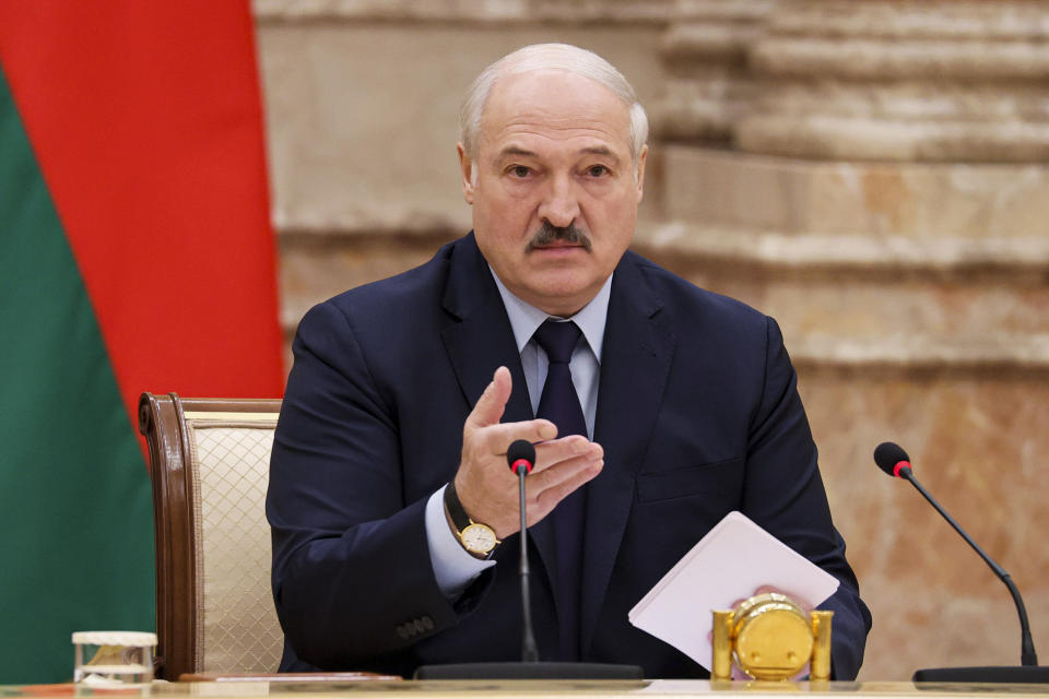 Belarusian President Alexander Lukashenko gestures as he speaks during an expanded meeting of the Constitutional Commission in Minsk, Belarus, Tuesday, Sept. 28, 2021. The authoritarian leader of Belarus announced a referendum on a new constitution in Feb. 2022 and promised not to let the opposition come to power. Alexander Lukashenko told a government meeting Tuesday he had drafted a new constitution that redistributes powers between the main branches of the government and establishes a new governing body, the All-Belarus People's Assembly. (Maxim Guchek/BelTA photo via AP)