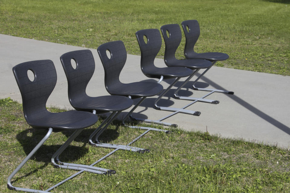 This June 14, 2019, photo shows a bank of chairs outside Wasilla Middle School that officials with Alaska Gov. Mike Dunleavy's administration said would accommodate adults if a special session were held in Wasilla, Alaska. Dunleavy has called lawmakers into special session in Wasilla beginning July 8, but some lawmakers have expressed concerns over security and logistics with the location more than 500 miles from the state capital of Juneau, Alaska. (AP Photo/Mark Thiessen)