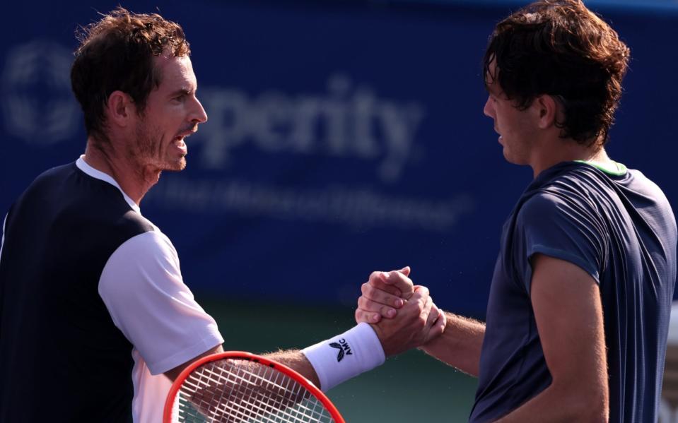 Andy Murray shakes hands with Taylor Fritz after their disrupted match