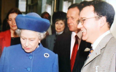 Dr Peter Fisher, pictured with the Queen, was a member of the royal medical household - Credit: David Sandison/REX/Shutterstock