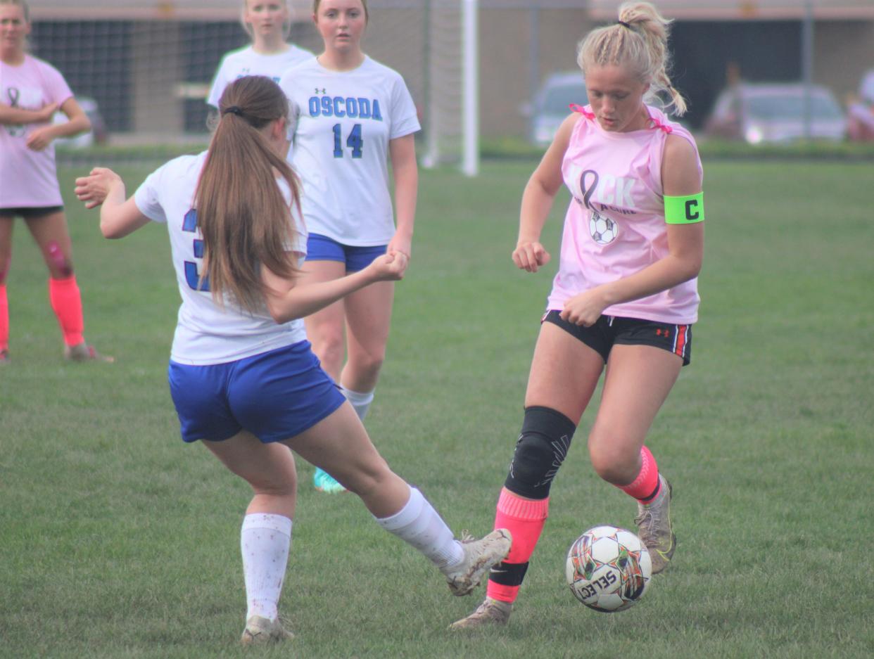Cheboygan senior midfielder Taylor Bent (right) controls the ball during a soccer game against Oscoda in Cheboygan on Wednesday. After being out for multiple weeks because of a knee injury, Bent returned to action for the Chiefs this week, scoring a combined four goals in wins over Roscommon and Oscoda.