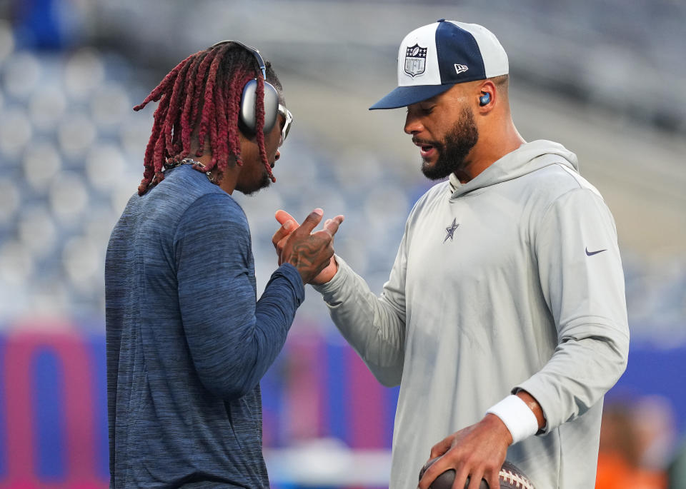 EAST RUTHERFORD, NEW JERSEY – SEPTEMBER 10: (L-R) <a class="link " href="https://sports.yahoo.com/nfl/players/32687" data-i13n="sec:content-canvas;subsec:anchor_text;elm:context_link" data-ylk="slk:CeeDee Lamb;sec:content-canvas;subsec:anchor_text;elm:context_link;itc:0">CeeDee Lamb</a> #88 and <a class="link " href="https://sports.yahoo.com/nfl/players/29369" data-i13n="sec:content-canvas;subsec:anchor_text;elm:context_link" data-ylk="slk:Dak Prescott;sec:content-canvas;subsec:anchor_text;elm:context_link;itc:0">Dak Prescott</a> #4 of the Dallas Cowboys warm up prior to a game against the New York Giants at MetLife Stadium on September 10, 2023 in East Rutherford, New Jersey. (Photo by Mitchell Leff/Getty Images)