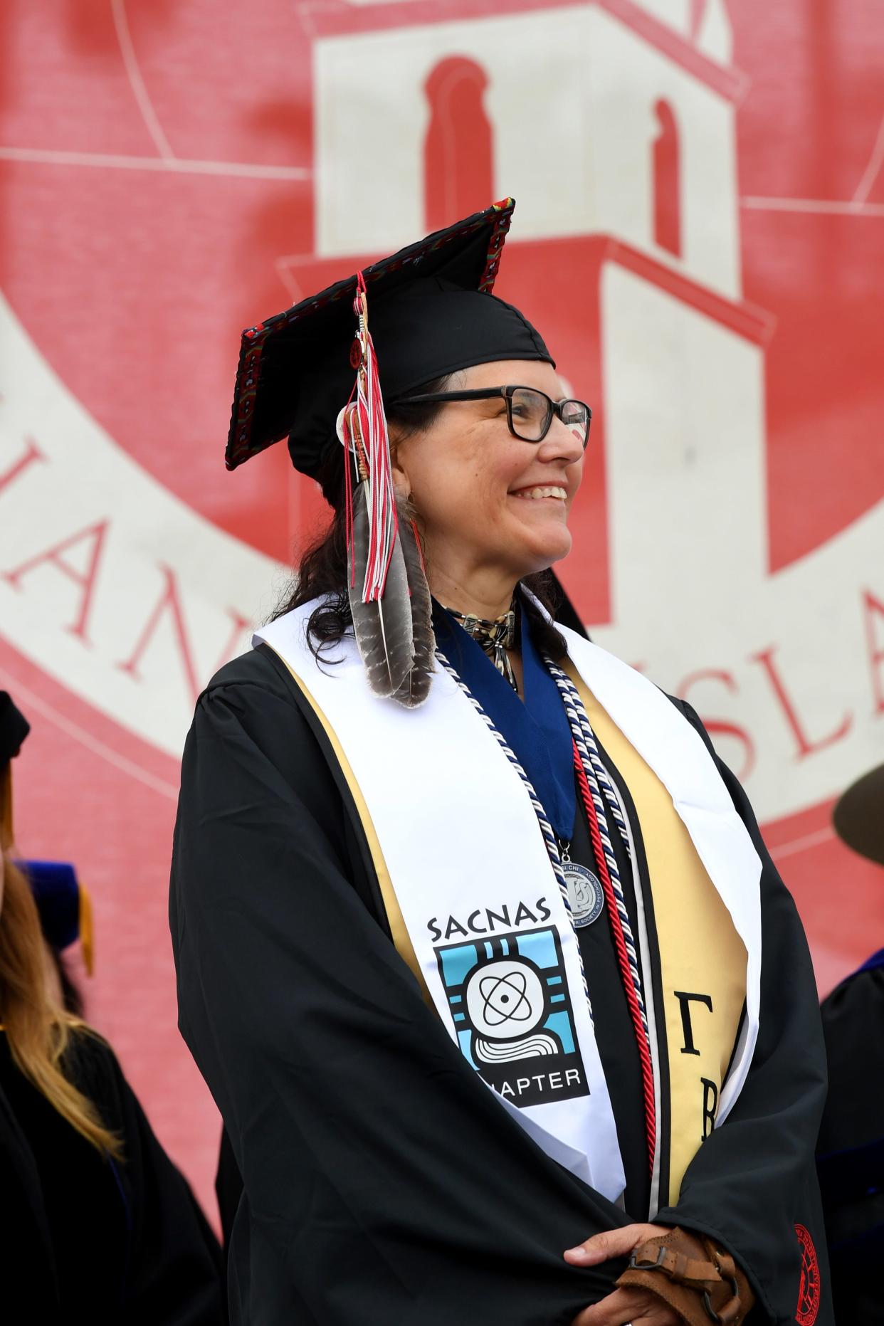 Spooner Greenbird stands on stage at the start of CSU Channel Islands' commencement on Saturday. Greenbird spoke at the Saturday morning ceremony. Nearly 1,200 students were expected to collect diplomas at events over the weekend.