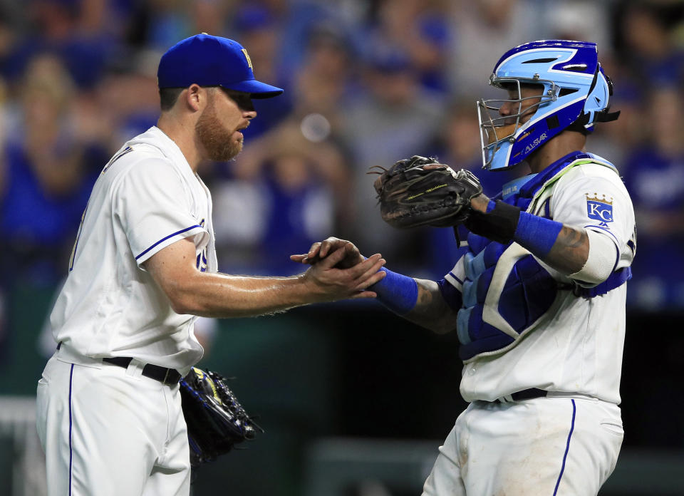 Kansas City Royals relief pitcher Ian Kennedy, left, shakes hands with catcher Martin Maldonado following the Royals' 8-5 win over the Detroit Tigers in a baseball game at Kauffman Stadium in Kansas City, Mo., Friday, July 12, 2019. (AP Photo/Orlin Wagner)